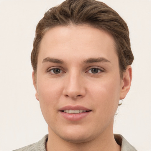 Joyful white young-adult female with short  brown hair and grey eyes