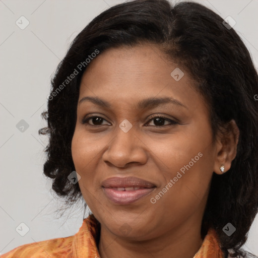 Joyful black adult female with medium  brown hair and brown eyes