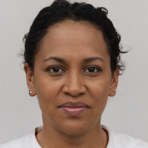 Joyful black adult female with short  brown hair and brown eyes