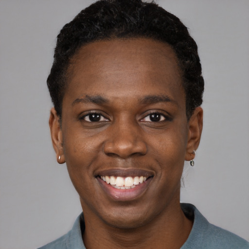 Joyful black young-adult female with short  black hair and brown eyes