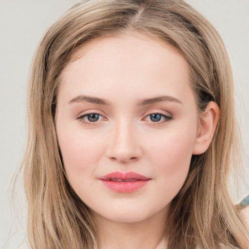 Joyful white young-adult female with long  brown hair and blue eyes