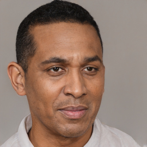 Neutral latino adult male with short  brown hair and brown eyes