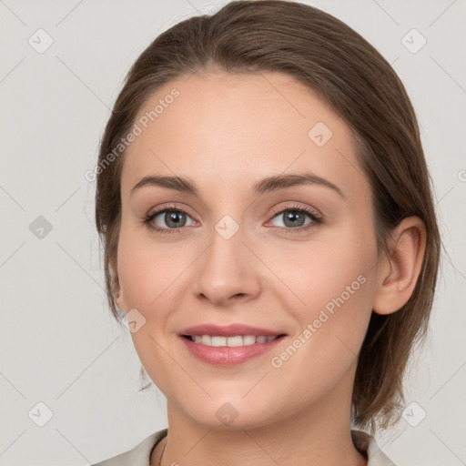 Joyful white young-adult female with medium  brown hair and grey eyes