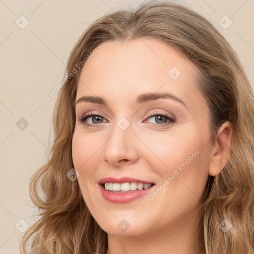 Joyful white young-adult female with long  brown hair and blue eyes