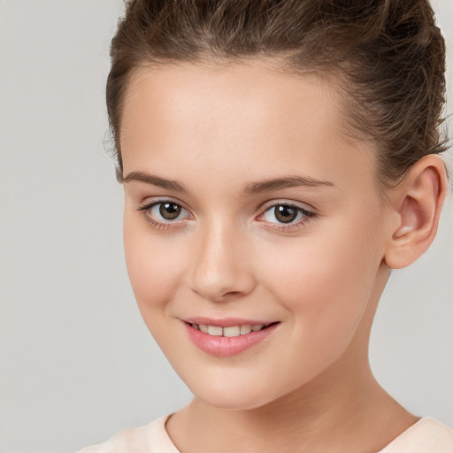 Joyful white child female with short  brown hair and brown eyes