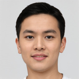 Joyful asian young-adult male with short  black hair and brown eyes