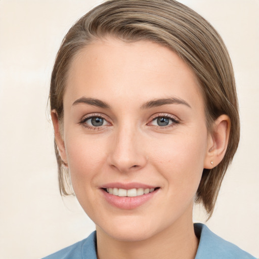 Joyful white young-adult female with medium  brown hair and grey eyes