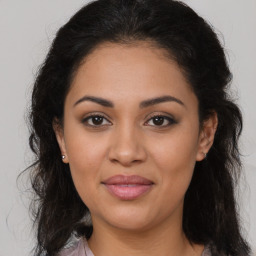 Joyful latino young-adult female with long  brown hair and brown eyes