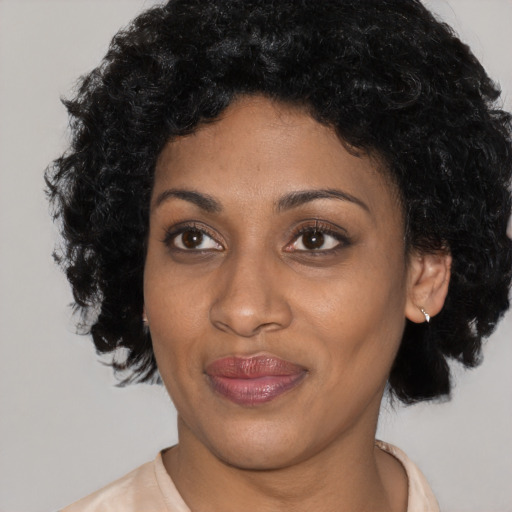 Joyful latino young-adult female with short  black hair and brown eyes