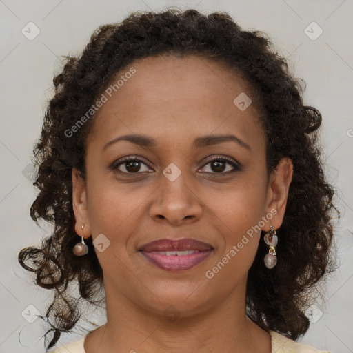 Joyful black young-adult female with long  brown hair and brown eyes