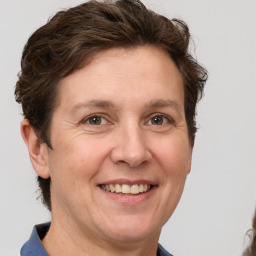 Joyful white adult female with short  brown hair and grey eyes