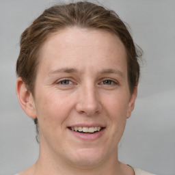 Joyful white adult female with short  brown hair and grey eyes