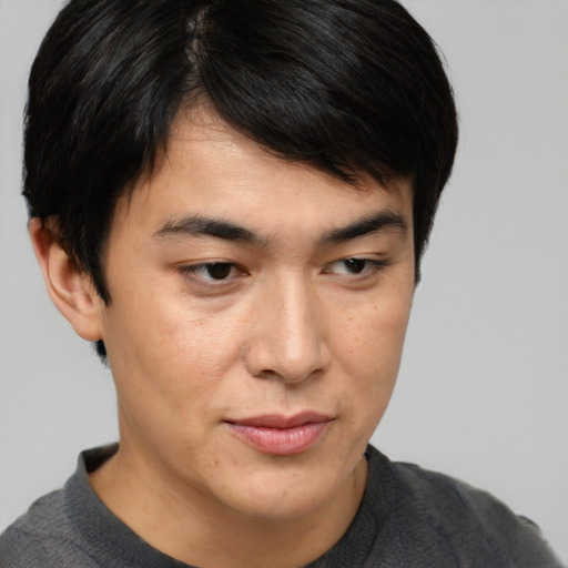 Joyful asian young-adult male with short  brown hair and brown eyes