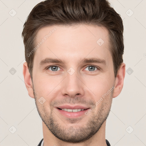 Joyful white young-adult male with short  brown hair and grey eyes