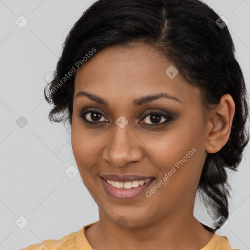 Joyful black young-adult female with medium  brown hair and brown eyes