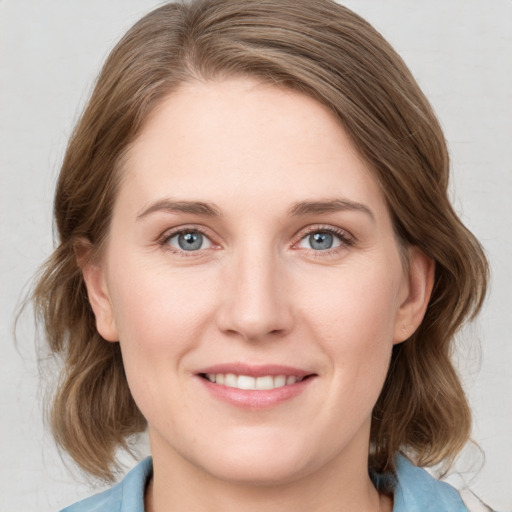 Joyful white young-adult female with medium  brown hair and blue eyes