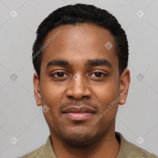 Joyful black young-adult male with short  black hair and brown eyes