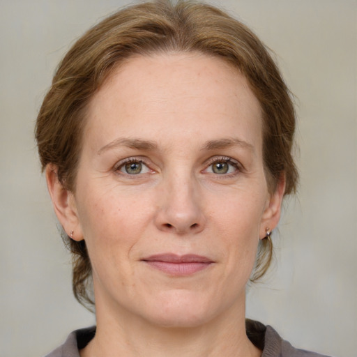 Joyful white adult female with medium  brown hair and blue eyes