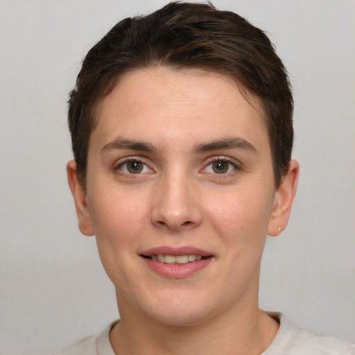 Joyful white young-adult female with short  brown hair and brown eyes