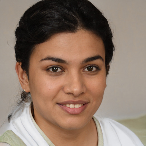 Joyful latino young-adult female with medium  brown hair and brown eyes
