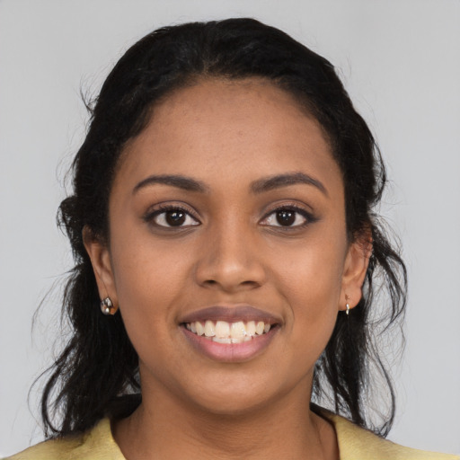 Joyful latino young-adult female with long  black hair and brown eyes