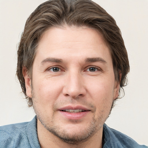 Joyful white adult male with short  brown hair and grey eyes