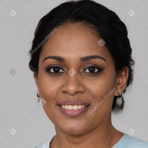 Joyful black young-adult female with short  black hair and brown eyes