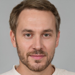 Joyful white adult male with short  brown hair and grey eyes