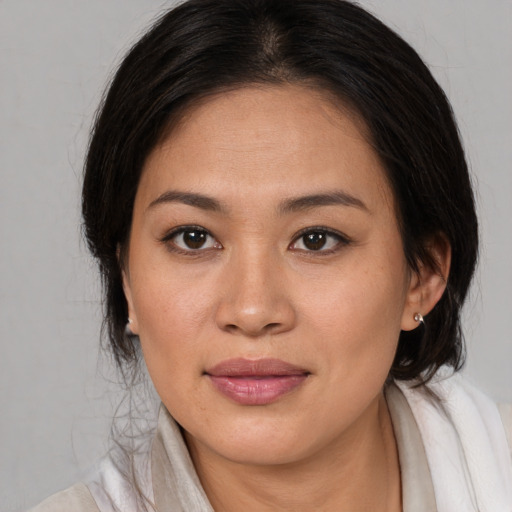 Joyful white young-adult female with medium  brown hair and brown eyes