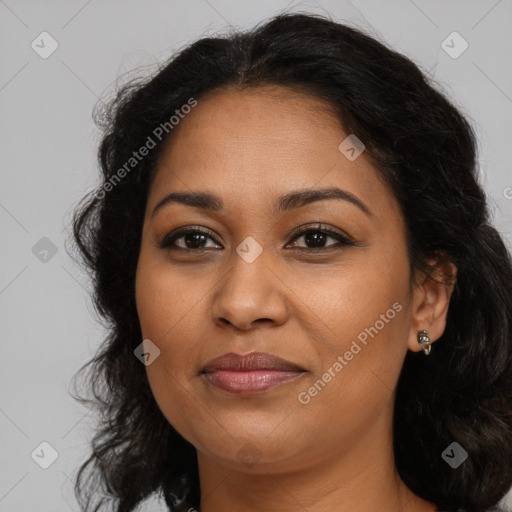 Joyful latino adult female with long  brown hair and brown eyes