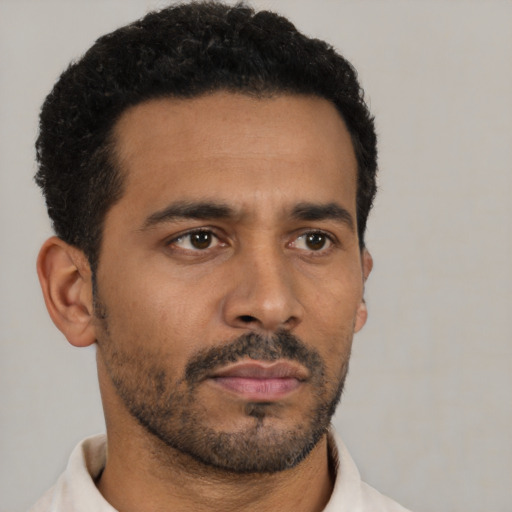 Neutral latino young-adult male with short  black hair and brown eyes