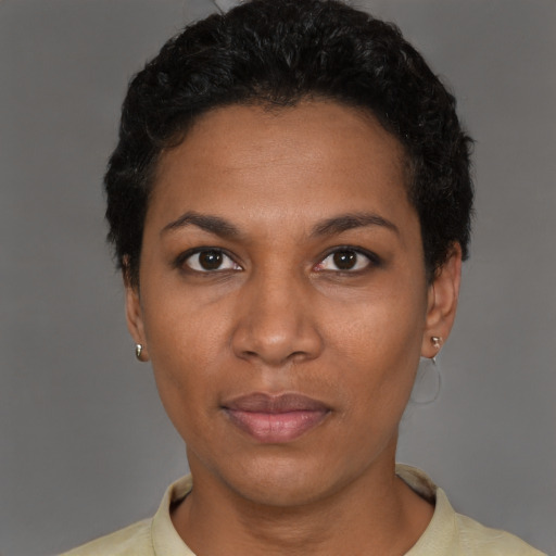 Joyful black adult female with short  black hair and brown eyes