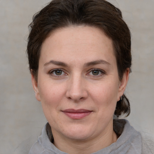 Joyful white adult female with medium  brown hair and grey eyes