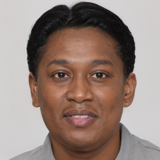 Joyful black adult male with short  black hair and brown eyes