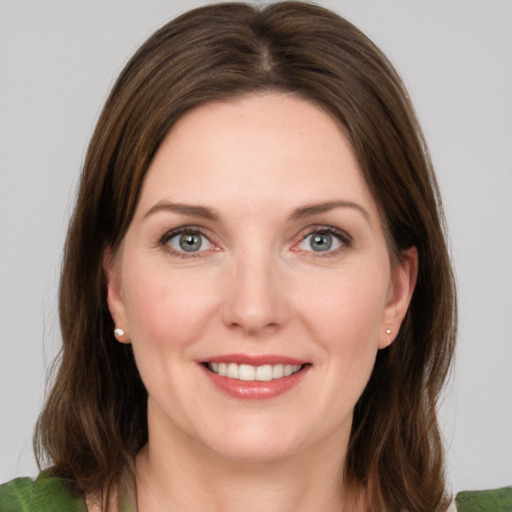 Joyful white young-adult female with medium  brown hair and green eyes