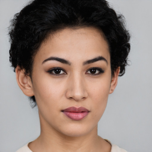 Joyful latino young-adult female with short  black hair and brown eyes