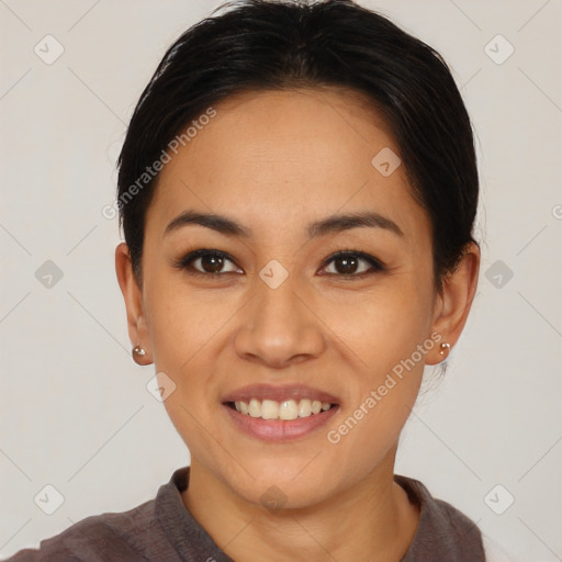 Joyful asian young-adult female with short  black hair and brown eyes