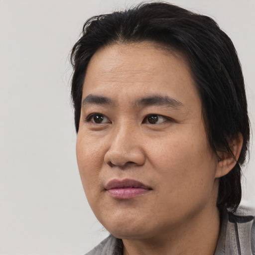 Joyful asian adult male with medium  black hair and brown eyes
