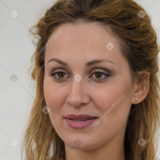 Joyful white adult female with long  brown hair and brown eyes