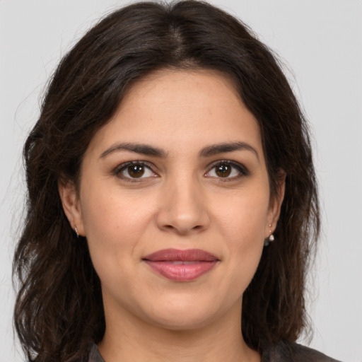 Joyful white young-adult female with long  brown hair and brown eyes