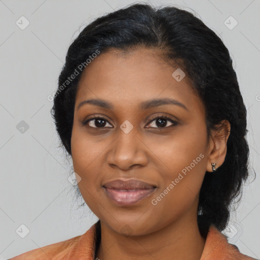 Joyful black young-adult female with long  black hair and brown eyes