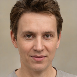 Joyful white adult male with short  brown hair and brown eyes