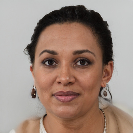 Joyful black adult female with short  brown hair and brown eyes