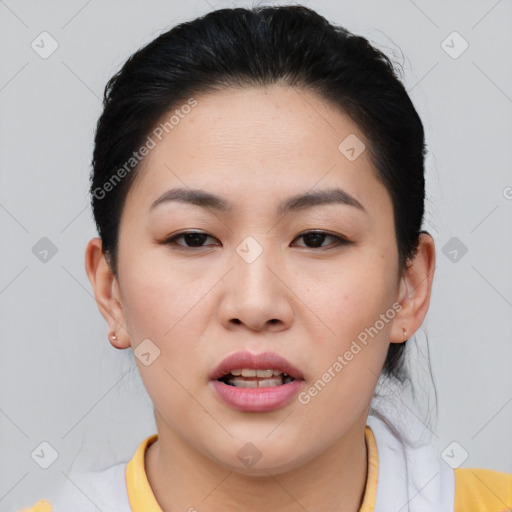 Joyful asian young-adult female with short  brown hair and brown eyes