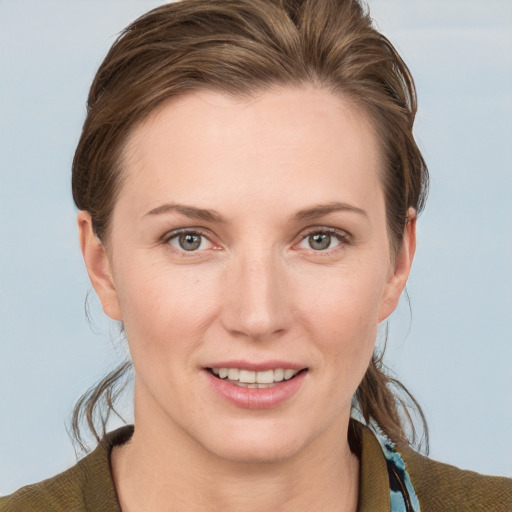 Joyful white young-adult female with short  brown hair and grey eyes