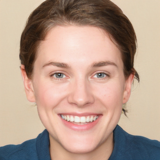 Joyful white young-adult female with medium  brown hair and blue eyes