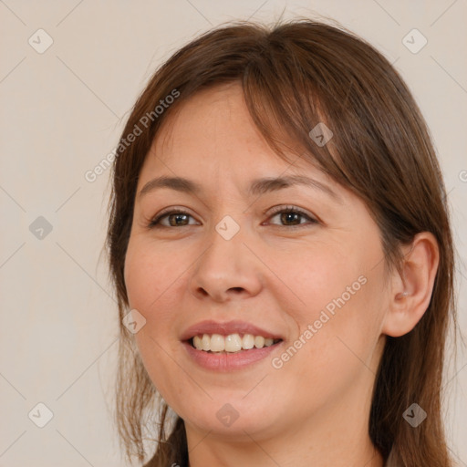 Joyful white young-adult female with long  brown hair and brown eyes