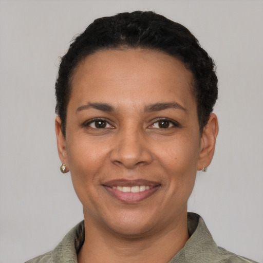 Joyful latino adult female with short  black hair and brown eyes