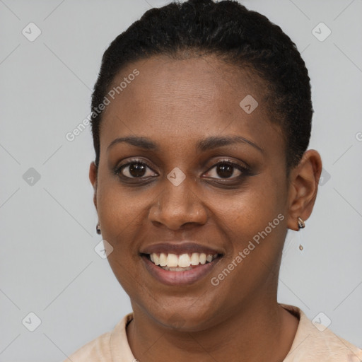 Joyful black young-adult female with short  black hair and brown eyes