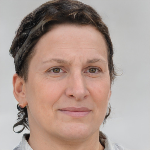 Joyful white adult female with medium  brown hair and blue eyes